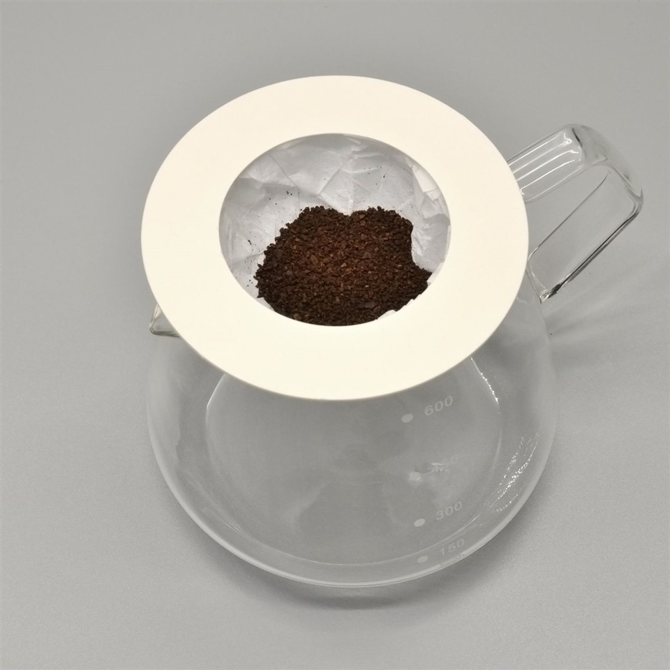 Tonchant Coffee Filters filled with ground coffee on a glass server